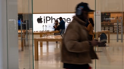 People walk by an Apple store in a shopping mall in lower Manhattan. (Getty Images via AFP) People walk by an Apple store in a shopping mall in lower Manhattan. (Getty Images via AFP)