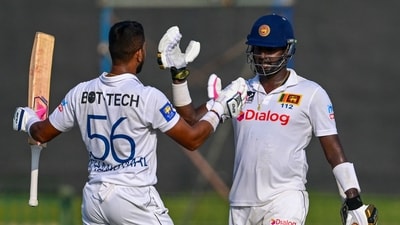 Dinesh Chandimal celebrates after scoring a century (100 runs) with Angelo Mathews (R) during Day 2 of the one-off Test cricket match between Sri Lanka and Afghanistan. (AFP) Dinesh Chandimal celebrates after scoring a century (100 runs) with Angelo Mathews (R) during Day 2 of the one-off Test cricket match between Sri Lanka and Afghanistan. (AFP)