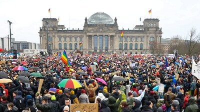 People gather outside the Reichstag building, during a rally of the broad alliance "Hand in Hand" under the slogan "Wir sind die Brandmauer" ("We are the Firewall") to protest against right-wing extremism and for the protection of democracy, in Berlin, Germany (REUTERS)