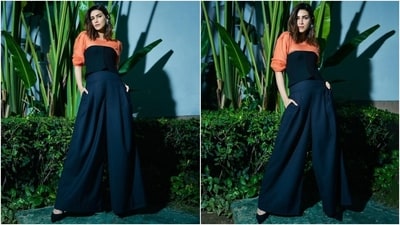 The second photoshoot shows Kriti dressed in an orange and black-hued attire. The actor wore a knit sweater featuring a round neckline, ribbed design, full-length sleeves, drop shoulders, and a relaxed fitting. She teamed a strapless ribbed black corset and high-waisted pleated black pants featuring a flared silhouette with the jumper to complete the look. (Instagram) The second photoshoot shows Kriti dressed in an orange and black-hued attire. The actor wore a knit sweater featuring a round neckline, ribbed design, full-length sleeves, drop shoulders, and a relaxed fitting. She teamed a strapless ribbed black corset and high-waisted pleated black pants featuring a flared silhouette with the jumper to complete the look. (Instagram)