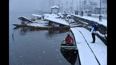 A boatman crossing Dal Lake during snowfall in Srinagar on Sunday. (Waseem Andrabi /HT) A boatman crossing Dal Lake during snowfall in Srinagar on Sunday. (Waseem Andrabi /HT)