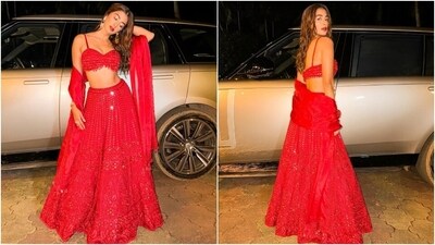 The red lehenga skirt features a high-rise waist, mirror embellishments, sequin cutdana hand embroidered in stunning patterns, an A-line silhouette, a floor-length hem, and a layered ghera. While the lehenga is made from an organza fabric, the blouse is made with net material. Lastly, Pooja completed the look with a hand-embroidered organza dupatta. (Instagram) The red lehenga skirt features a high-rise waist, mirror embellishments, sequin cutdana hand embroidered in stunning patterns, an A-line silhouette, a floor-length hem, and a layered ghera. While the lehenga is made from an organza fabric, the blouse is made with net material. Lastly, Pooja completed the look with a hand-embroidered organza dupatta. (Instagram)