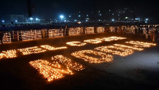 BJP supporters light earthen pots to welcome PM Modi on his arrival at the Veterinary College field in Guwahati on Saturday.(ANI)