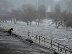 A man walks his dog on the edge of the Los Angeles River, carrying stormwater downstream Sunday, Feb. 4, 2024, in Los Angeles AP Photo/Damian Dovarganes) A man walks his dog on the edge of the Los Angeles River, carrying stormwater downstream Sunday, Feb. 4, 2024, in Los Angeles AP Photo/Damian Dovarganes)