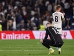 Real Madrid's German midfielder #08 Toni Kroos and Real Madrid's Ukrainian goalkeeper #13 Andriy Lunin react at the end of the game Real Madrid's German midfielder #08 Toni Kroos and Real Madrid's Ukrainian goalkeeper #13 Andriy Lunin react at the end of the game