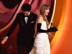US singer-songwriter Taylor Swift (R) accepts the Best Pop Vocal Album award for "Midnights" alongside South African comedian and host Trevor Noah on stage during the 66th Annual Grammy Awards at the Crypto.com Arena in Los Angeles on February 4, 2024. (Photo by Valerie Macon / AFP)