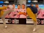 A fan kicks Lionel Messi's head out of cardboard cut-out. A fan kicks Lionel Messi's head out of cardboard cut-out.