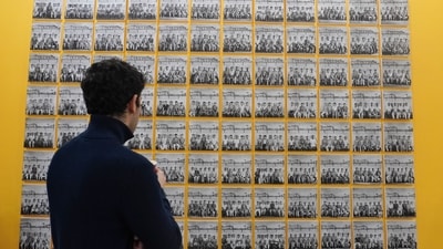 At the PHOTOINK booth, a visitor looks at ‘Assembly, 1952’ by Ahmed Ali. Created from his pioneering industrial work, this collage of probably the factory’s entire workforce, is a set of 96 photographs all shot at the Machinery Manufacturers Corporation Ltd. Calcutta in 1952. ( Paroma Mukherjee/ Hindustan Times) At the PHOTOINK booth, a visitor looks at ‘Assembly, 1952’ by Ahmed Ali. Created from his pioneering industrial work, this collage of probably the factory’s entire workforce, is a set of 96 photographs all shot at the Machinery Manufacturers Corporation Ltd. Calcutta in 1952. ( Paroma Mukherjee/ Hindustan Times)