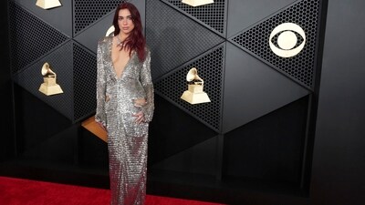 Dua Lipa embraced Disco Ball genre for her look of the night at Grammy Awards dressed in a silver metallic dress featuring cut-outs on the side and a plunging neckline. Her red hair parted in the middle, a choker necklace, and minimal makeup glammed up the gown. &nbsp; (AP)