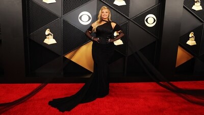 Bebe Rexha posed on the Grammy red carpet in a stunning black gown that featured an off-the-shoulder neckline, attached fishnet sleeves, a fitted bust and a floor-sweeping hemline, the extra netted fabric attached to the shoulder of her dress added an added glam factor to her look making it a complete showstopper. (REUTERS/Mario Anzuoni)