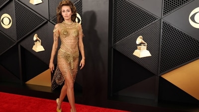 Miley Cyrus' red carpet appearance at the Grammys is definitely the look of the season. The pop star, known for her bold fashion choices, opted for an outfit made almost entirely of gold safety pins. She paired her almost-nude gown with gold velvet Tabi heels by Maison Margiela and jewellery by Tiffany &amp; Co. She turned heads with a dramatic up-do of her brunette locks and a nude make-up look. (REUTERS/Mario Anzuoni)