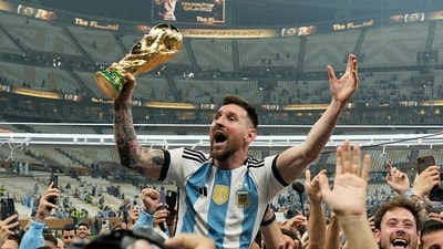 FILE - Argentina's Lionel Messi celebrates with the trophy in front of the fans after winning the World Cup final match between Argentina and France (AP)