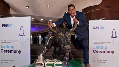Paytm Crisis: Paytm founder and CEO Vijay Shekhar Sharma poses with a bronze replica of a bull at the Bombay Stock Exchange (BSE) in Mumbai. (Reuters)