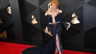 Ice Spice blurred the line between casual and couture at the 66th Grammy Awards. She wore a denim gown featuring a train at the back, white and beige fur adornments, a thigh-high slit. and a bodycon fitting.&nbsp; (AFP)