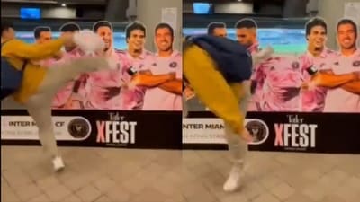 A fan kicks Lionel Messi's head out of cardboard cut-out. A fan kicks Lionel Messi's head out of cardboard cut-out.