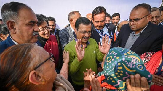 CM Arvind Kejriwal with pilgrims departing for Tirupati at Thyagaraj Stadium in the city on Monday. (Sanchit Khanna/HT Photo)