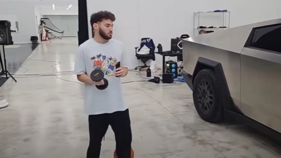 Adin Ross throws a dumbbell at his Tesla Cybertruck (Adin Ross/YouTube)