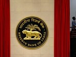 RBI Monetary Policy meeting: A worker walks past the logo of Reserve Bank of India (RBI) inside its office in New Delhi, India.