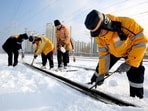 Workers clear ice and snow off the tracks along Lianyungang East railway station, during the Spring Festival travel rush ahead of the Chinese Lunar New Year, in Lianyungang, Jiangsu province, China. Weather woes for China's holiday travellers: Freezing rain and snow disrupt Spring Festival plans 