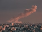 A picture taken from Rafah in the southern Gaza Strip shows smoke rising over buildings in Khan Yunis.