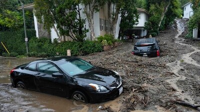 Vehicles are damaged by a mudslide in the Beverly Crest area of Los Angeles. A storm of historic proportions unleashed record levels of rain over parts of Los Angeles on Monday, endangering the city's large homeless population, sending mud and boulders down hillsides dotted with multimillion-dollar homes and knocking out power for more than a million people in California. (AP) Vehicles are damaged by a mudslide in the Beverly Crest area of Los Angeles. A storm of historic proportions unleashed record levels of rain over parts of Los Angeles on Monday, endangering the city's large homeless population, sending mud and boulders down hillsides dotted with multimillion-dollar homes and knocking out power for more than a million people in California. (AP)