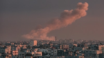 A picture taken from Rafah in the southern Gaza Strip shows smoke rising over buildings in Khan Yunis. (AFP) A picture taken from Rafah in the southern Gaza Strip shows smoke rising over buildings in Khan Yunis. (AFP)