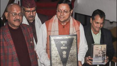 Uttarakhand chief minister Pushkar Singh Dhami holds a copy of the Constitution of India at the Vidhan Sabha Bhawan in Dehradun on Tuesday. (PTI) Uttarakhand chief minister Pushkar Singh Dhami holds a copy of the Constitution of India at the Vidhan Sabha Bhawan in Dehradun on Tuesday. (PTI)
