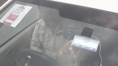Paytm FASTag: A man points to the FASTag on his vehicle's windshield, at the toll office at Kherki-Daula toll plaza, in Gurugram.