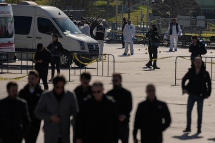Security officers check the site where two attackers were killed outside a courthouse in Istanbul on February 6. (AP) Security officers check the site where two attackers were killed outside a courthouse in Istanbul on February 6. (AP)