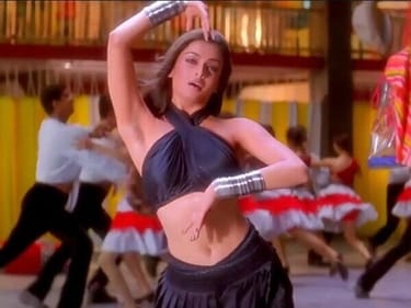 Aishwarya Rai in a black halter neck crop top and draped skirt in Taal (1999) Aishwarya Rai in a black halter neck crop top and draped skirt in Taal (1999)