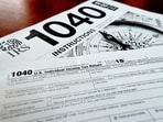 FILE- Internal Revenue Service taxes forms are seen on Feb. 13, 2019. If you have unpaid or unfiled taxes, the start of a new tax season and the looming reminders of debt might fill you with dread. But it’s best to take care of back taxes sooner rather than later: The longer you put off the task, the more you’ll pay in interest and penalties. Even if you can’t pay in full, you can still take meaningful steps toward addressing the debt. To handle your overdue taxes, read any tax notices you’ve received, set up a payment plan, contact a professional for complicated situations and remember to file a return for the current year. (AP Photo/Keith Srakocic, File) FILE- Internal Revenue Service taxes forms are seen on Feb. 13, 2019. If you have unpaid or unfiled taxes, the start of a new tax season and the looming reminders of debt might fill you with dread. But it’s best to take care of back taxes sooner rather than later: The longer you put off the task, the more you’ll pay in interest and penalties. Even if you can’t pay in full, you can still take meaningful steps toward addressing the debt. To handle your overdue taxes, read any tax notices you’ve received, set up a payment plan, contact a professional for complicated situations and remember to file a return for the current year. (AP Photo/Keith Srakocic, File)
