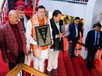 Uttarakhand Chief Minister Pushkar Singh Dhami with others holds a copy of the Constitution of India, at Vidhan Sabha Bhawan, in Dehradun. Uttarakhand Chief Minister Pushkar Singh Dhami with others holds a copy of the Constitution of India, at Vidhan Sabha Bhawan, in Dehradun.
