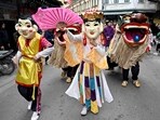 Performers and lion dancers take part in a procession for the upcoming Lunar New Year in Hanoi on January 28, 2024. (Photo by Nhac NGUYEN / AFP)
