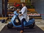Bhavish Aggarwal, co-founder and CEO of Ola, poses for a photograph with the new Ola electric scooter during its launch at the Ola headquarters in Bangalore on August 15, 2021. (AFP)
