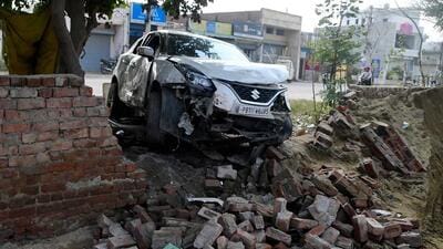 The car crashed into a wall after hitting the group sitting by a bonfire on the Tharike-Sua road in Ludhiana. (HT Photo)