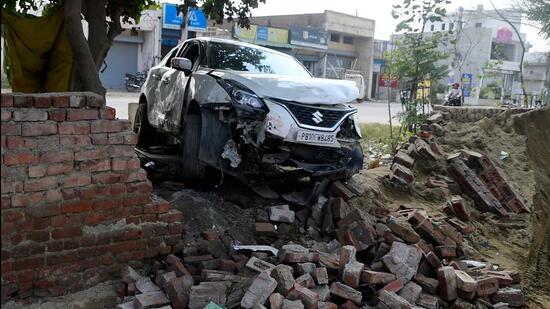 The car crashed into a wall after hitting the group sitting by a bonfire on the Tharike-Sua road in Ludhiana. (HT Photo)