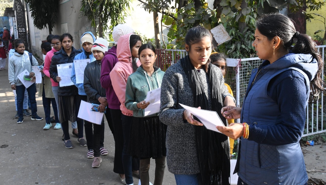 Students standing in queue to appear in the Bihar Board class 12th examination at D.D. Nandan Kanya High School Danapur in Patna 
Photo by Santosh Kumar