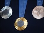 The Chaumet-designed Paris 2024 Olympic gold, silver and bronze medals, featuring a hexagon-shaped piece of iron taken from the original Eiffel Tower, The Chaumet-designed Paris 2024 Olympic gold, silver and bronze medals, featuring a hexagon-shaped piece of iron taken from the original Eiffel Tower,