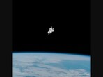 The image shows astronaut Bruce McCandless II moving in space unattached to a craft. The image shows astronaut Bruce McCandless II moving in space unattached to a craft.