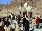 People hold black flags as they boycott voting during the general election as part of a protest against authorities for not fulfilling their demands, at Landi Kotal in Khyber Pakhtunkhwa province, Pakistan