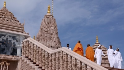 Monks and visitors in traditional Emirati clothes walk at the BAPS Hindu Mandir temple, in Abu Dhabi, United Arab Emirates. (REUTERS)