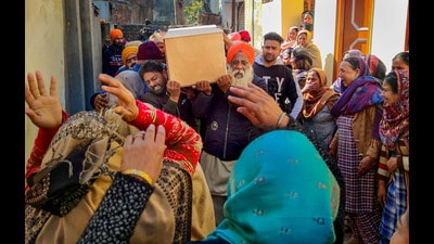 Family members carry mortal remains of Amritpal Singh who was killed in a terrorist attack in J&K's Srinagar, at his residence, on the outskirts of Amritsar on Thursday. (PTI) Family members carry mortal remains of Amritpal Singh who was killed in a terrorist attack in J&K's Srinagar, at his residence, on the outskirts of Amritsar on Thursday. (PTI)