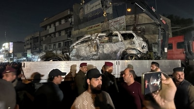People gather as a destroyed vehicle is loaded onto a truck, after what security sources said was a deadly drone strike, in Baghdad, Iraq, February 7, 2024. REUTERS/Ahmed Saad (REUTERS)