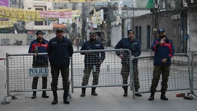 Policemen stand guard outside a polling station before the start of voting in Pakistan's national elections in Lahore. (AFP) Policemen stand guard outside a polling station before the start of voting in Pakistan's national elections in Lahore. (AFP)