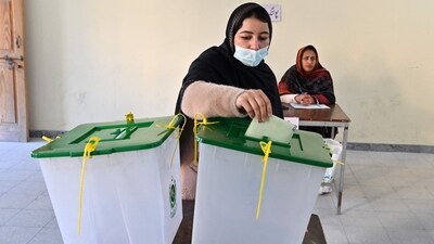 A woman cast her ballot at a polling station during Pakistan's national elections in Islamabad on February 8. (AFP) A woman cast her ballot at a polling station during Pakistan's national elections in Islamabad on February 8. (AFP)