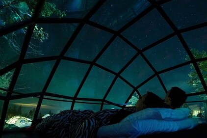 Watching the northern lights in an igloo hotel in Finland (Shutterstock) Watching the northern lights in an igloo hotel in Finland (Shutterstock)