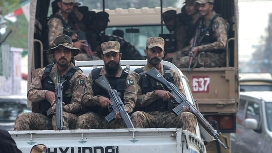 Army personnel patrol on vehicles along a street during the Pakistan's national elections in Karachi on February 8.(AFP)