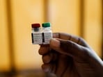 A nurse holds malaria vaccine vials before administering it to an infant at the Lumumba Sub-County hospital in Kisumu, Kenya.