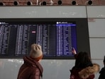Travellers check departure flights information on a display at the Beijing Capital International Airport. Thailand, Malaysia, Singapore hope to lure tourists from China with visa-free travel. 