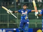 Sri Lanka's Pathum Nissanka (L) celebrates after scoring a double century (200 runs) as Charith Asalanka during the first one-day international